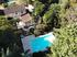 A view of the house and pool from a drone